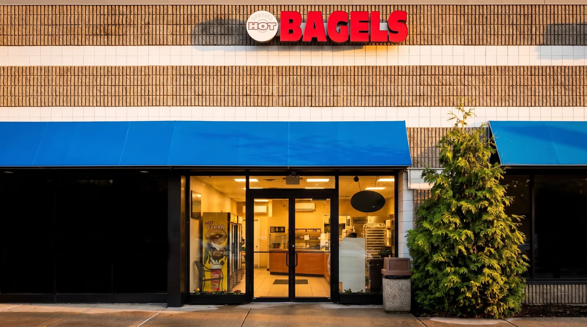 The Perry's Bagel Cafe storefront on Route 17 South, a blue awning under a red BAGELS sign.